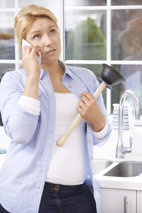 woman-on-the-phone-while-holding-a-plunger