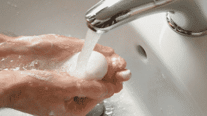 woman-letting-soap-run-under-water-faucet